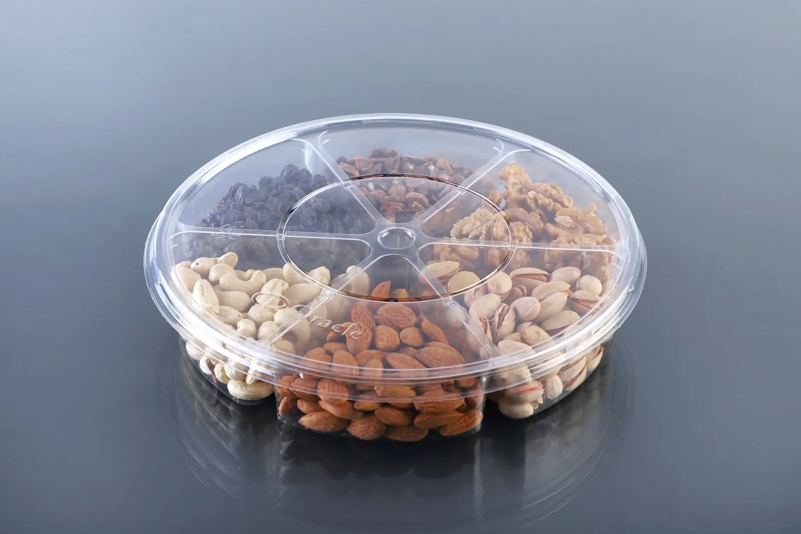 Round Oracle PET tray divided into compartments, filled with mixed dry fruits and nuts