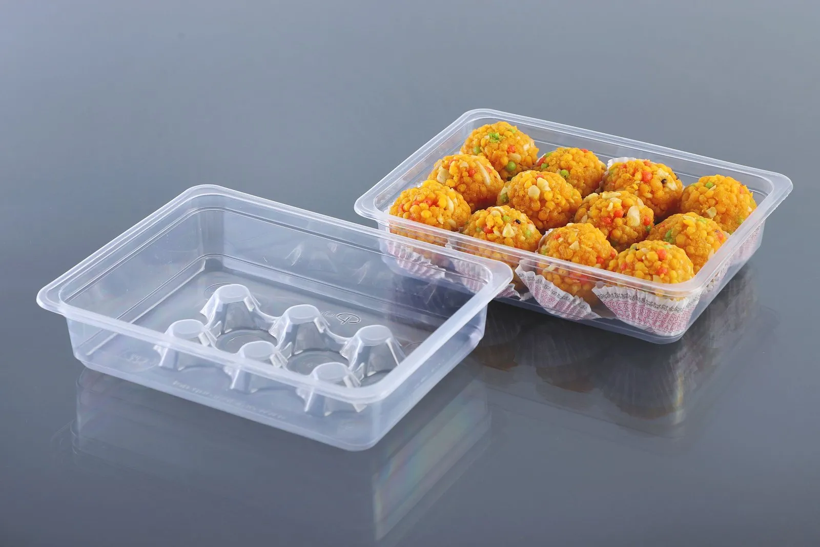Oracle rectangular PP tray filled with laddus beside a matching empty tray