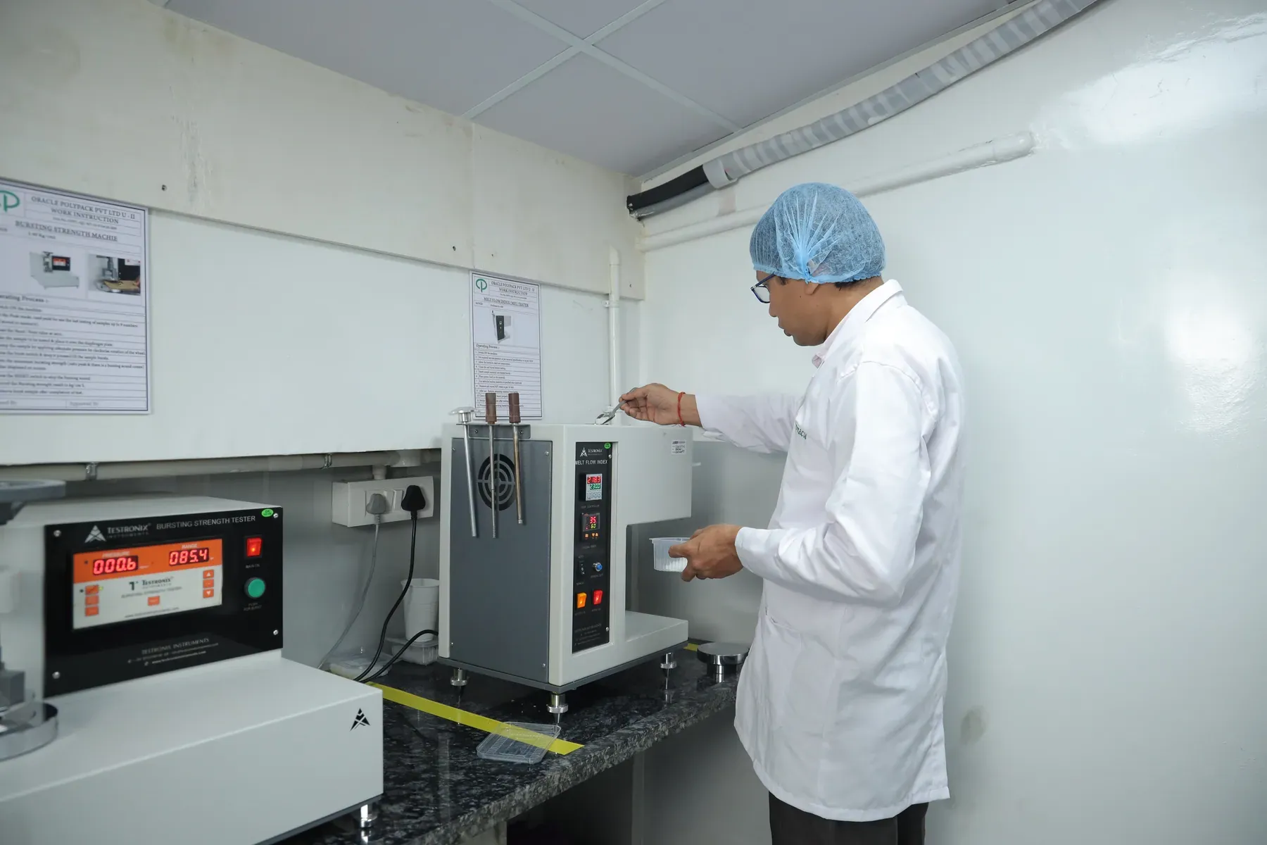 Quality team member testing a clear food container in the laboratory